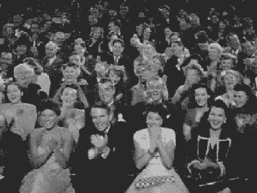 An audience clapping.